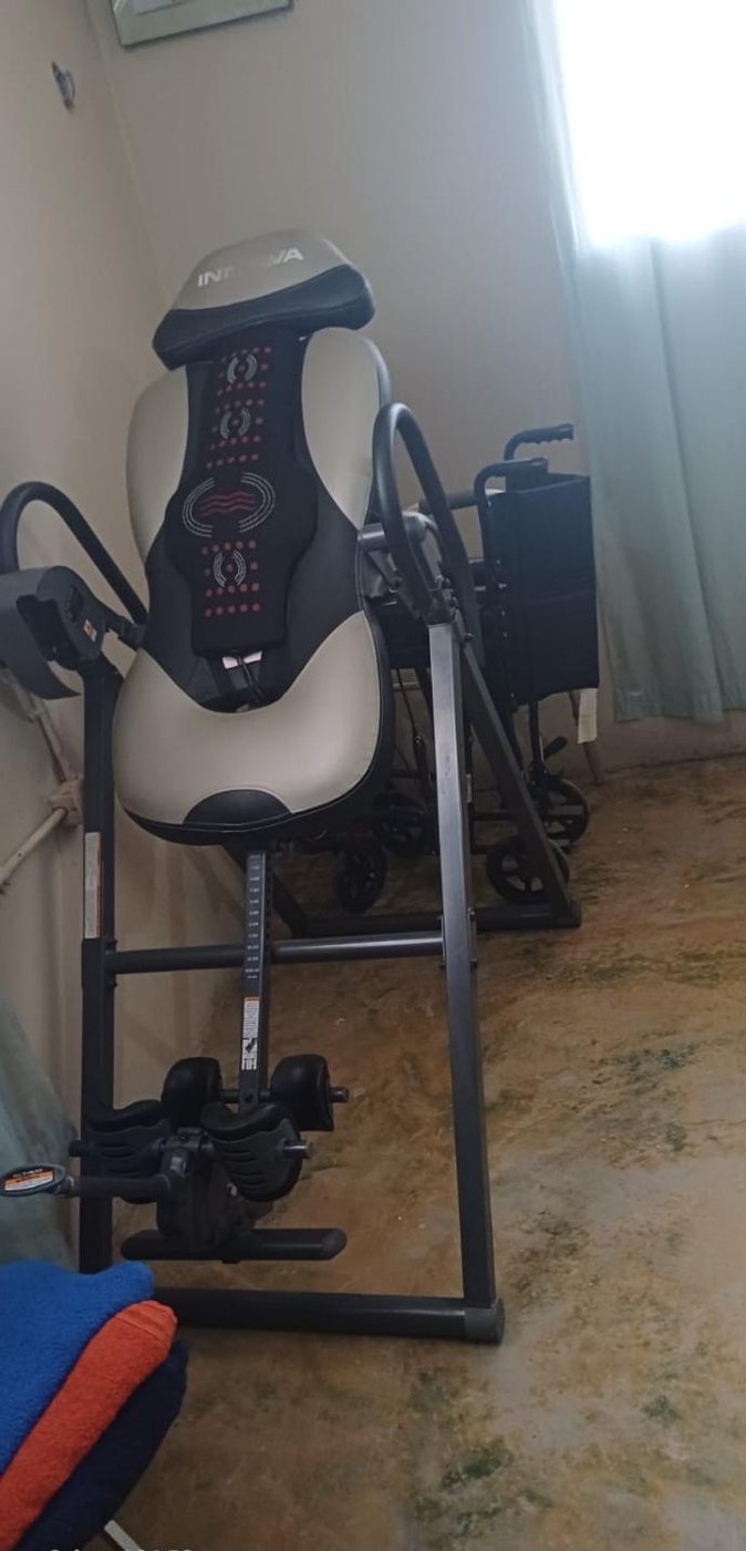 Inversion table and a wheelchair in the rehabilitation room in Los Naranjos, Santa Cruz de Yojoa.
